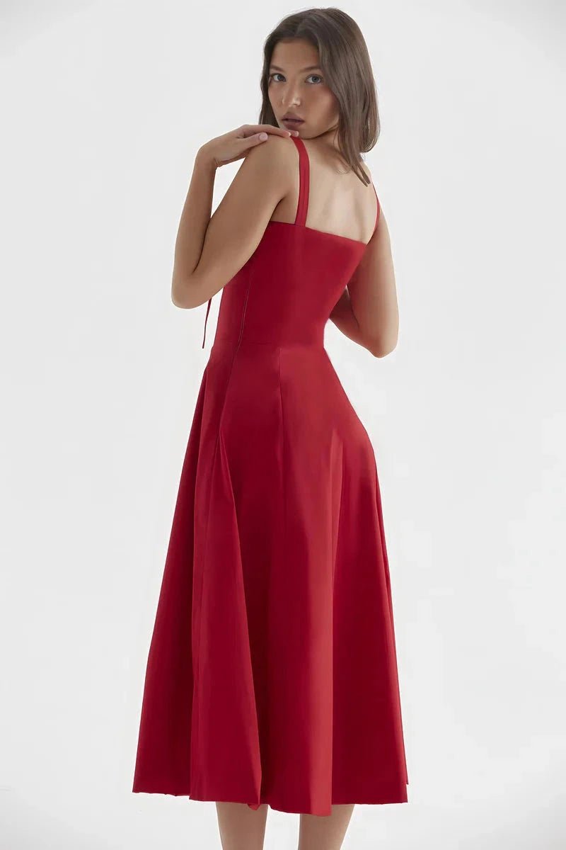 Red Linsay - Woman wearing a floral sweetheart midi dress with wide straps, a fitted bodice, and a flowing A-line skirt with a front slit.