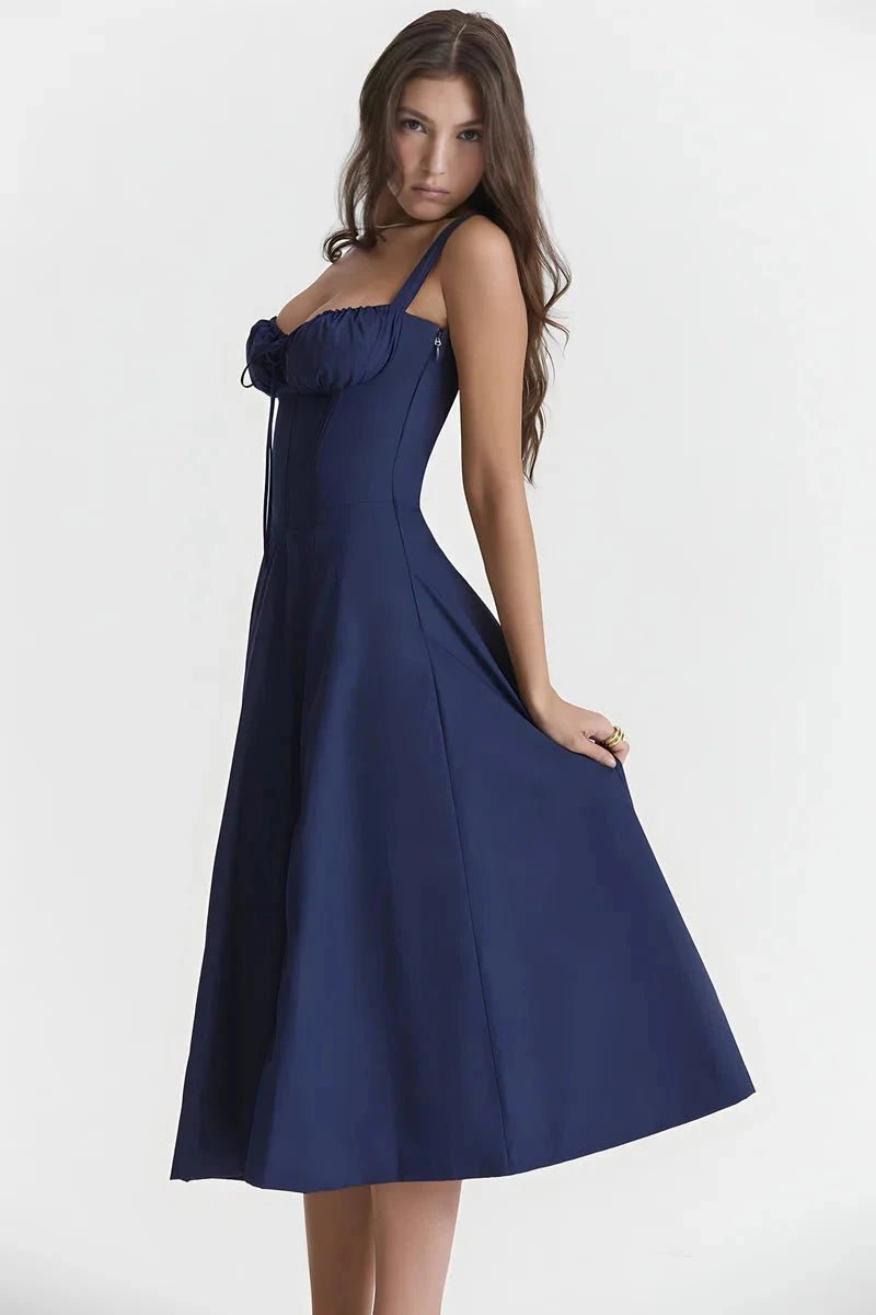 Navy Blue Linsay - Woman wearing a floral sweetheart midi dress with wide straps, a fitted bodice, and a flowing A-line skirt with a front slit.