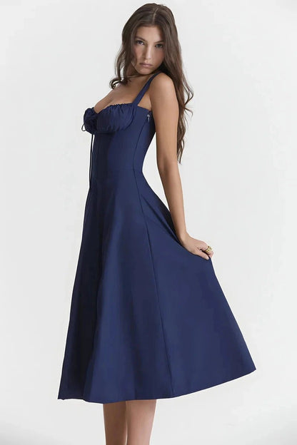 Navy Blue Linsay - Woman wearing a floral sweetheart midi dress with wide straps, a fitted bodice, and a flowing A-line skirt with a front slit.