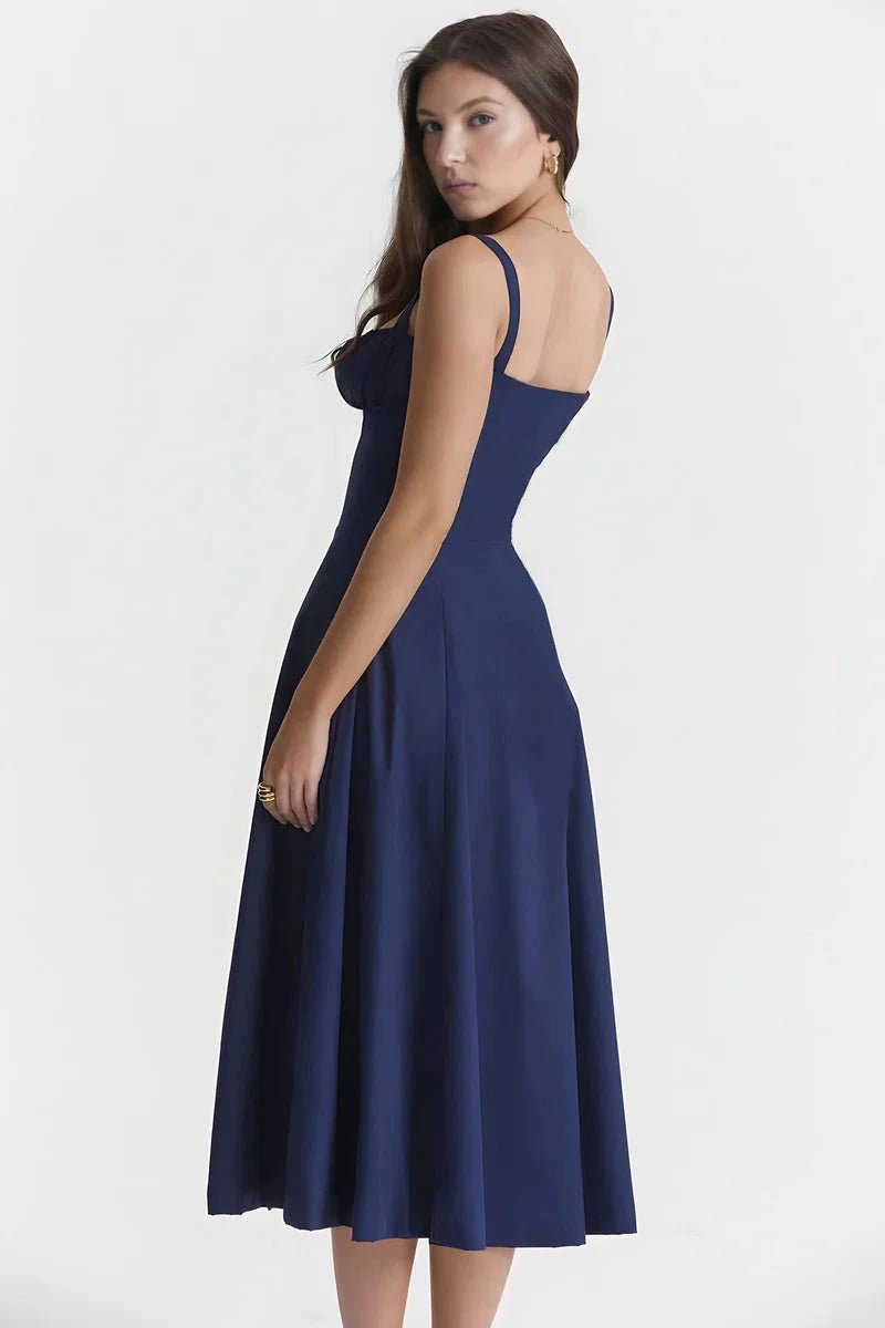 Navy Blue Linsay - Woman wearing a floral sweetheart midi dress with wide straps, a fitted bodice, and a flowing A-line skirt with a front slit.