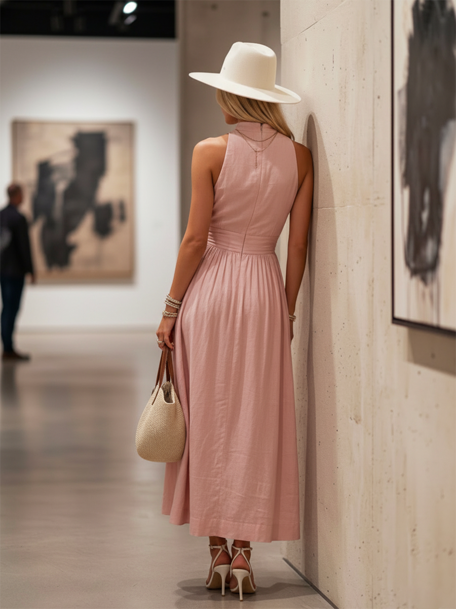 Teal - Woman walking outdoors in a desert landscape wearing a lightweight, sleeveless plunging V-neck maxi dress with a wide banded waist and side button details.