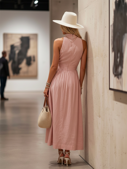 Teal - Woman walking outdoors in a desert landscape wearing a lightweight, sleeveless plunging V-neck maxi dress with a wide banded waist and side button details.