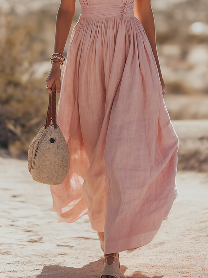 Teal - Woman walking outdoors in a desert landscape wearing a lightweight, sleeveless plunging V-neck maxi dress with a wide banded waist and side button details.