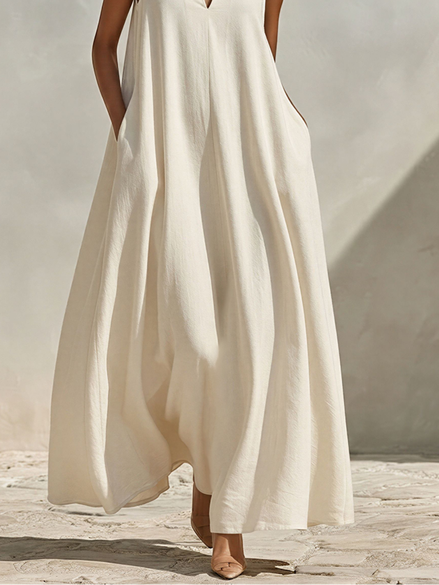 Cream - A model wearing a voluminous, sleeveless woven maxi dress with a deep V-neck and stand collar, standing outdoors.